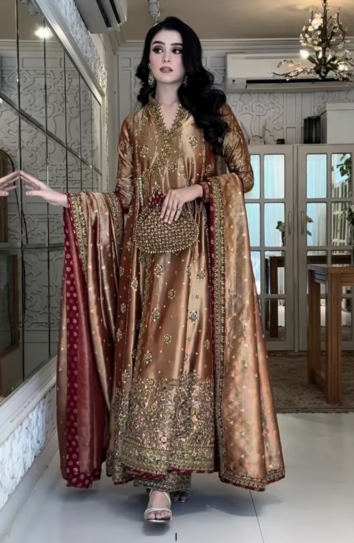 Haris Shakeel Aswad Pakistani fashion outfit in gold tones.